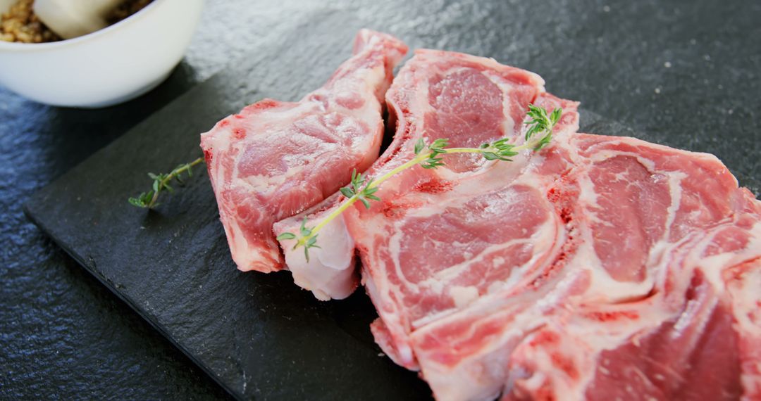 Raw Pork Chops with Thyme on Slate Board for Culinary Creations - Free Images, Stock Photos and Pictures on Pikwizard.com