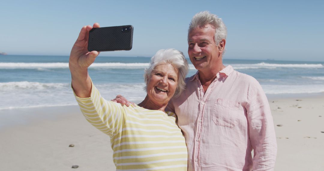 Senior Couple Taking Selfie on Beach During Sunny Day - Free Images, Stock Photos and Pictures on Pikwizard.com