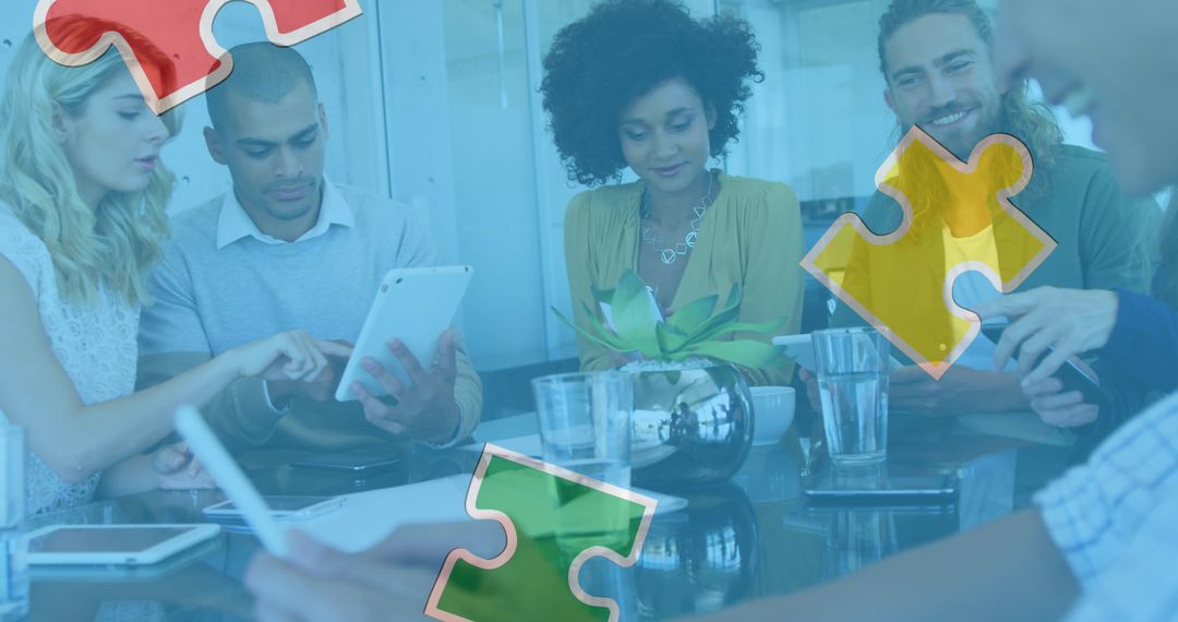 Diverse Team Collaborating with Digital Devices and Puzzle Graphics