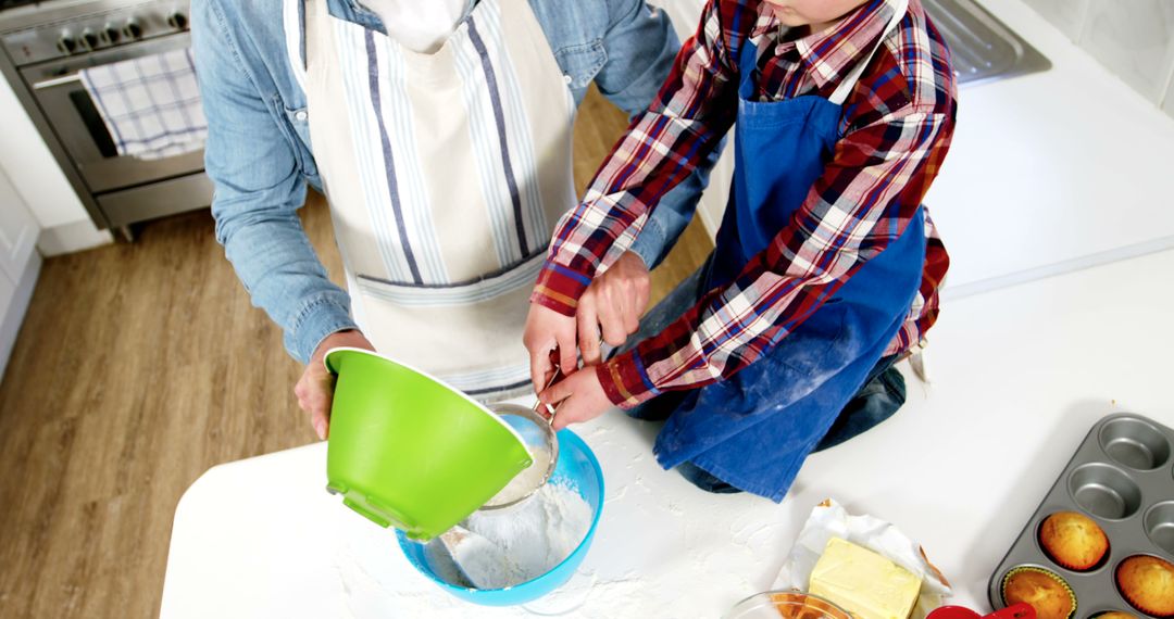 Father and Son Baking Together in Kitchen Wearing Aprons - Free Images, Stock Photos and Pictures on Pikwizard.com