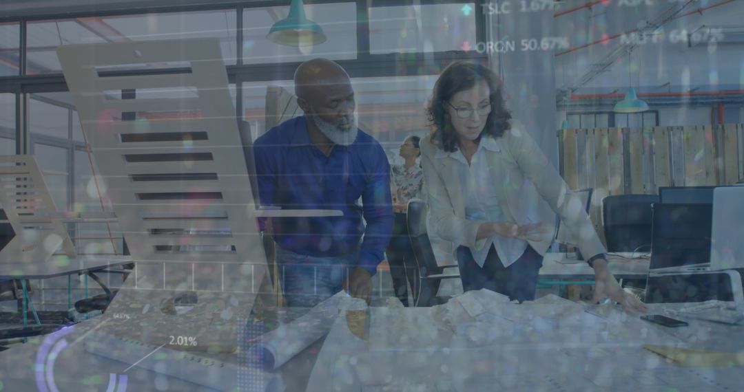 Architects Collaborating on Blueprints in Modern Office Space