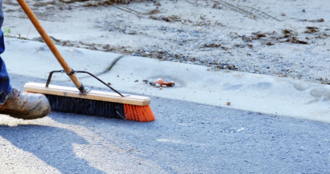 Worker Sweeping Sidewalk with Broom During Construction - Free Images, Stock Photos and Pictures on Pikwizard.com