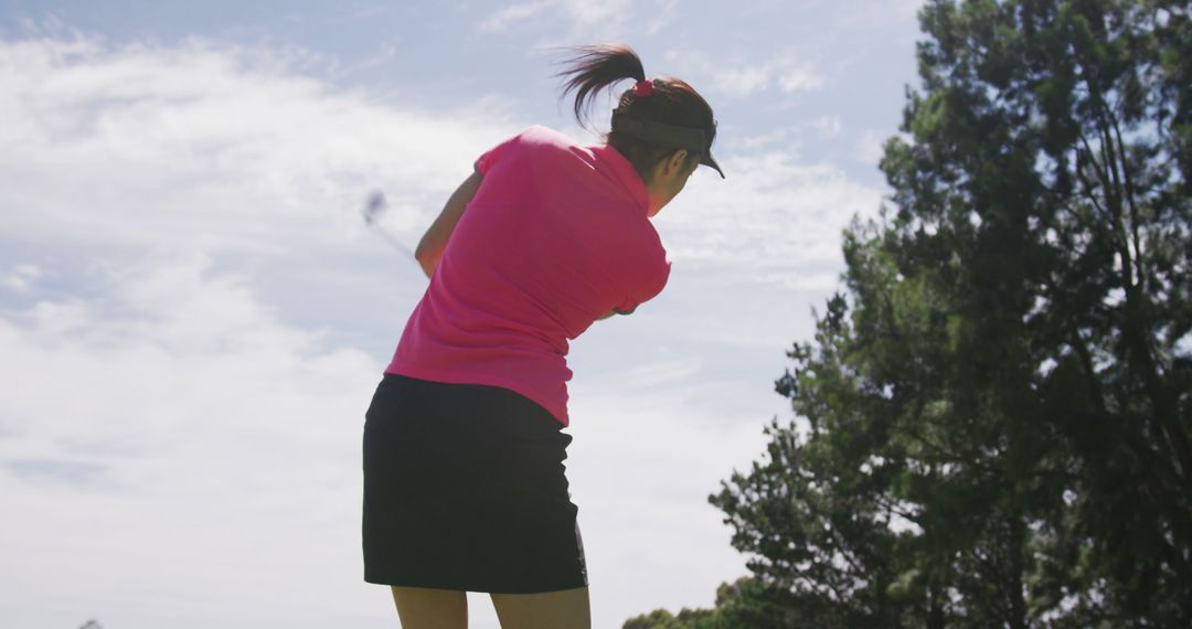 Female Golfer Swinging Golf Club Outdoors on Sunny Day - Free Images, Stock Photos and Pictures on Pikwizard.com