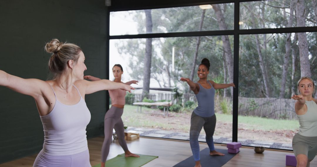 Multiethnic Group of Women Practicing Yoga in Bright Studio - Free Images, Stock Photos and Pictures on Pikwizard.com