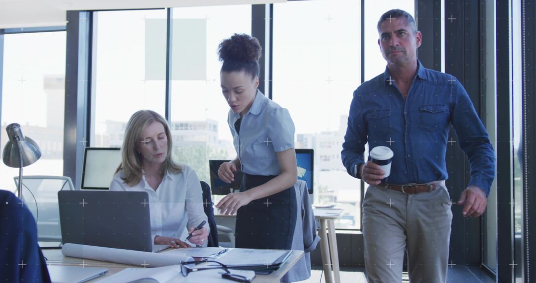 Business Team Collaborating on Blueprints in Modern Office