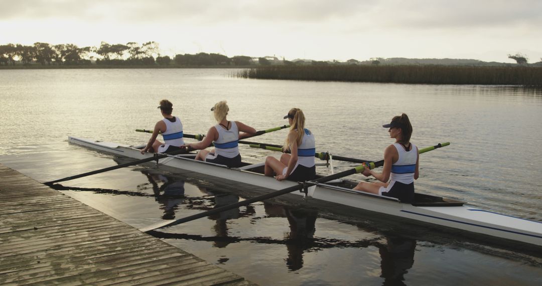 Female Team Rowing on Lake During Sundown - Free Images, Stock Photos and Pictures on Pikwizard.com