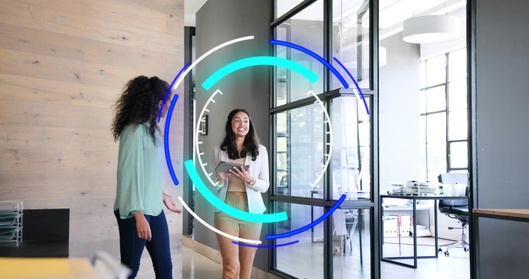 Young professional walking glass office holding tablet with circular HUD overlay collaborating