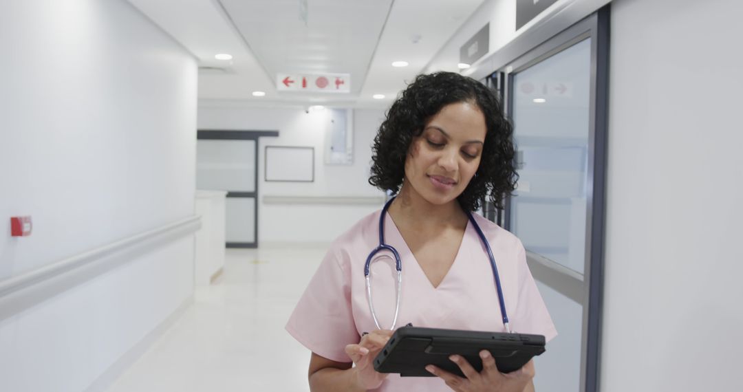 Confident Nurse Using Digital Tablet in Modern Hospital Hallway - Free Images, Stock Photos and Pictures on Pikwizard.com