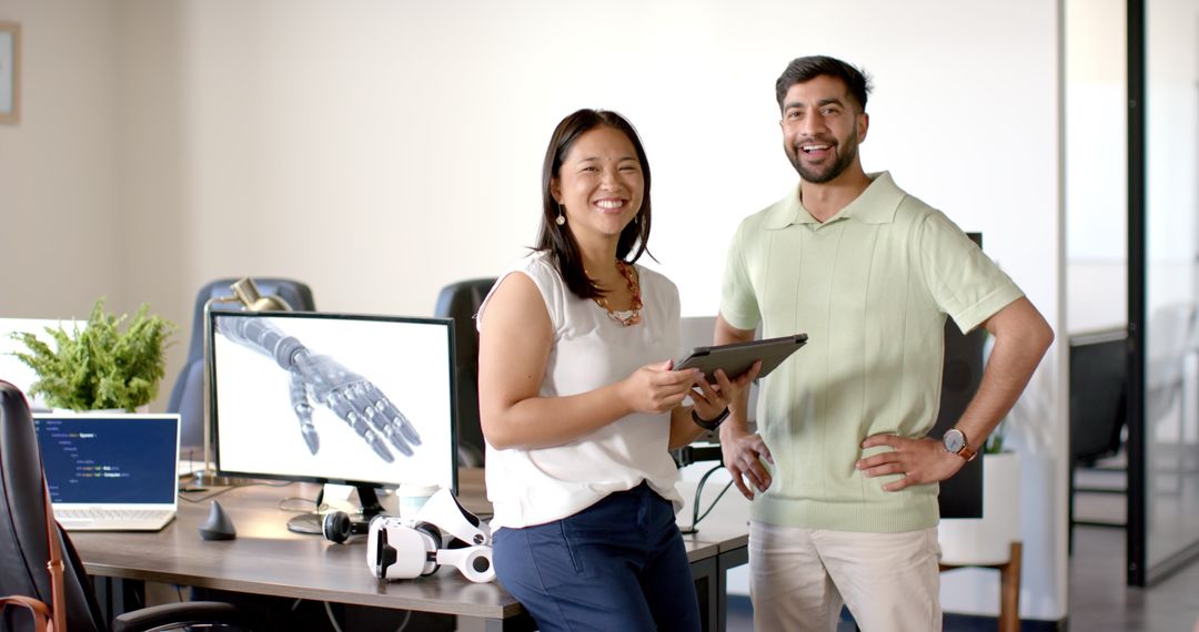 Colleagues Discussing Robotic Hand Design in Modern Office Environment