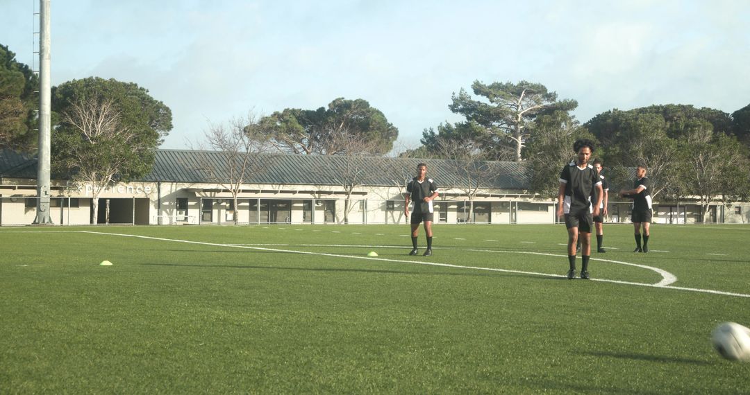 Coach Instructing Young Soccer Players for Enhanced Teamwork