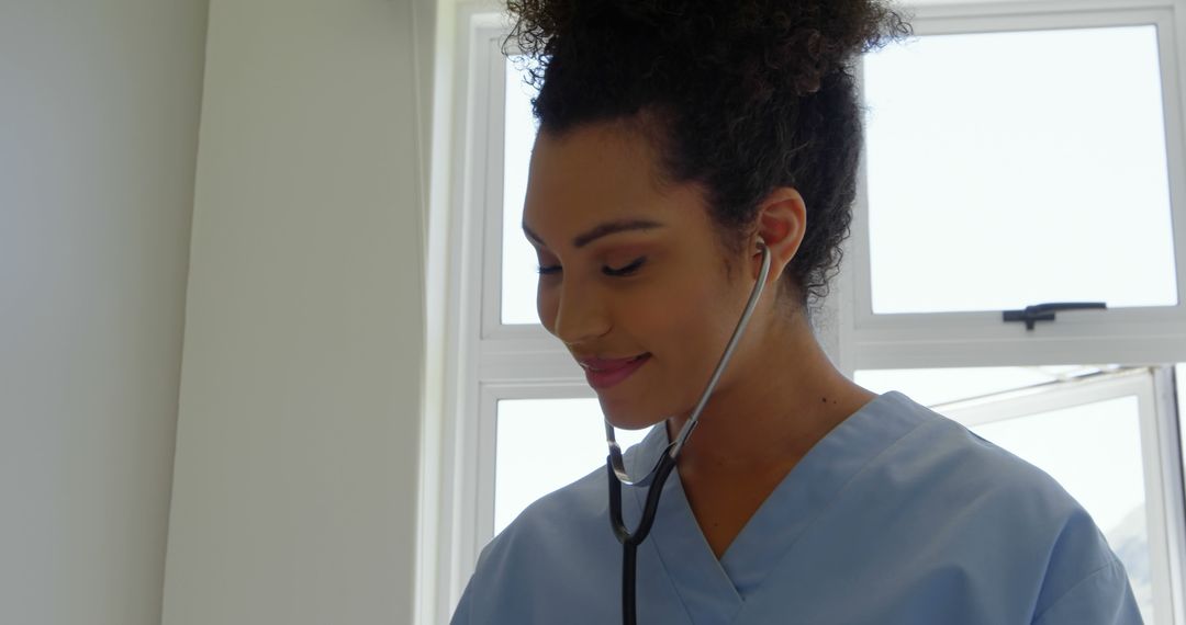 Smiling Female Doctor Listening to Heartbeat with Stethoscope - Free Images, Stock Photos and Pictures on Pikwizard.com