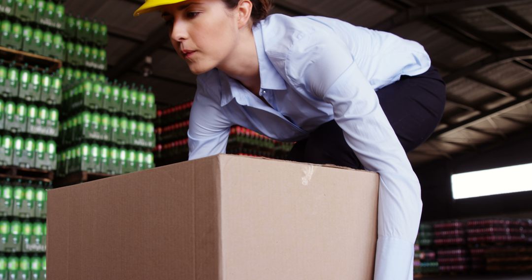 Warehouse Worker Lifting Heavy Box with Caution - Free Images, Stock Photos and Pictures on Pikwizard.com