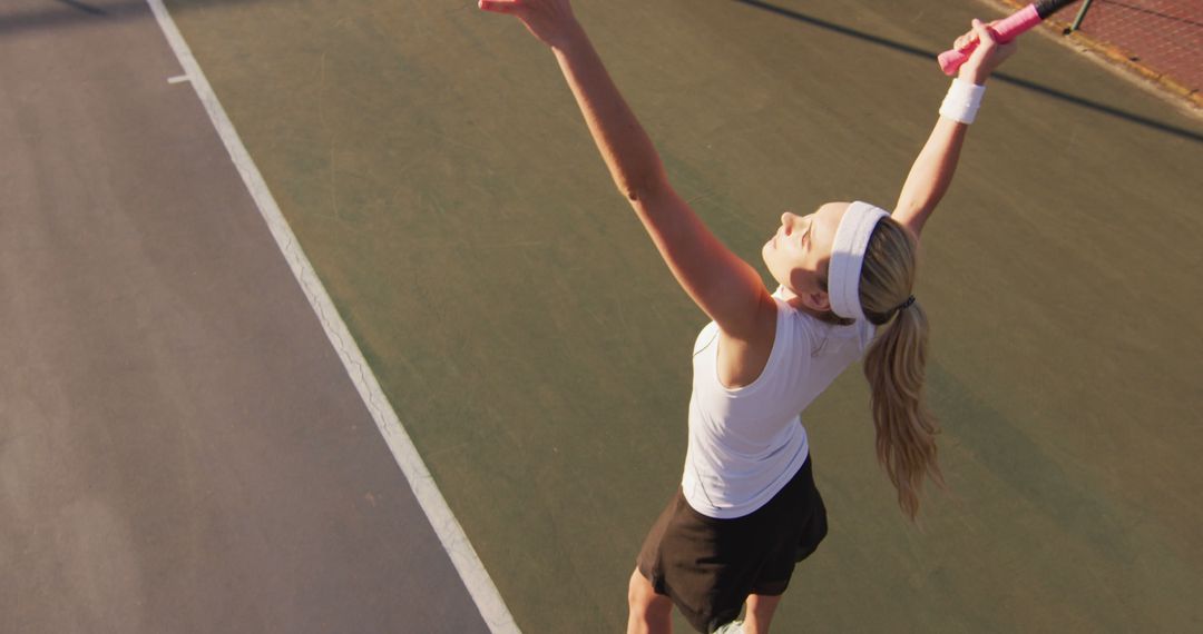 Female Tennis Player Serving on Outdoor Clay Court - Free Images, Stock Photos and Pictures on Pikwizard.com