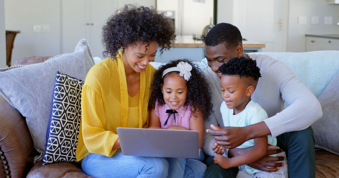 Happy African American Family Using Laptop on Sofa At Home - Free Images, Stock Photos and Pictures on Pikwizard.com