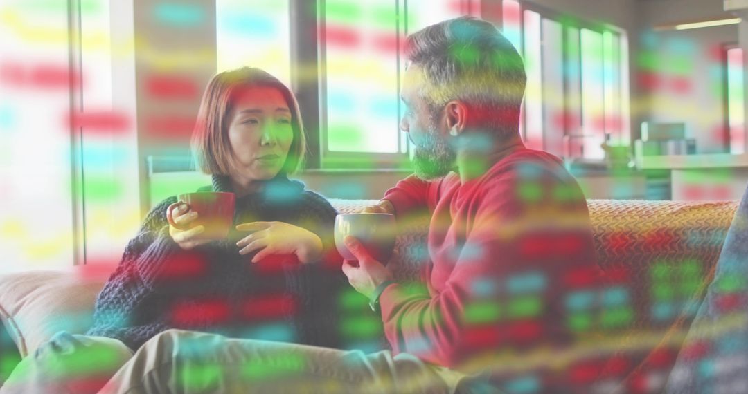 Couple Sipping Coffee on Sofa Wearing Chunky Sweaters with Colorful Data Overlay