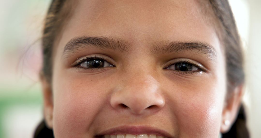 Close-Up of Young Girl Smiling with Joy and Innocence