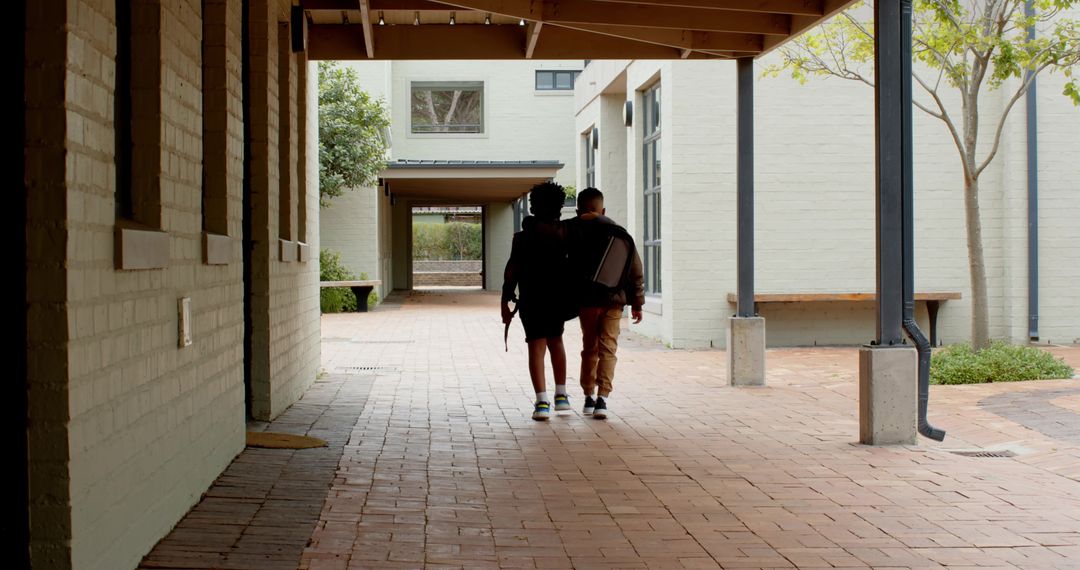 School Friends Strolling on Campus Walkway with Backpacks