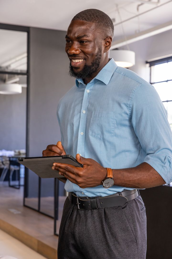 Confident Professional Analyzing Plans with Digital Tablet