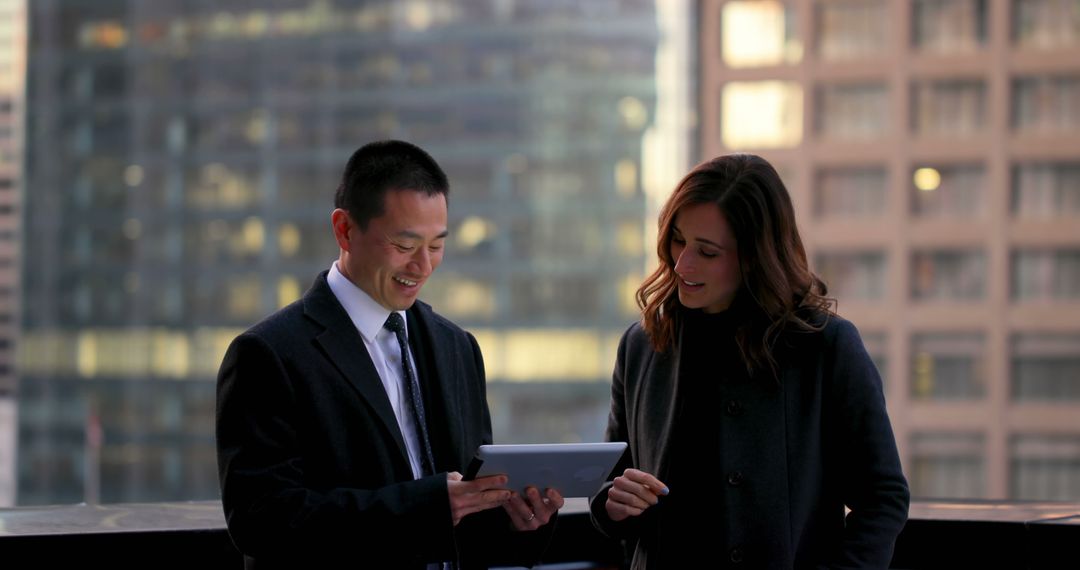 Business Professionals Collaborating with Tablet on Urban Balcony
