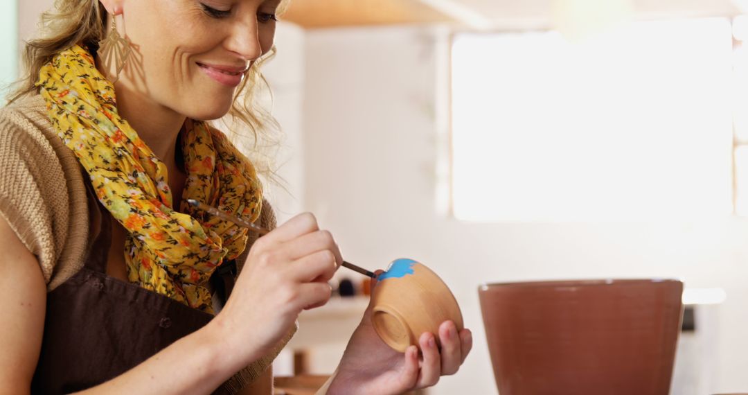 Woman Painting Ceramic Bowl in Pottery Studio - Free Images, Stock Photos and Pictures on Pikwizard.com