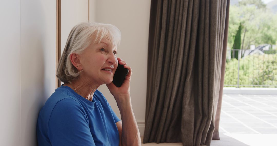 Smiling Senior Woman Relaxing and Talking on Smartphone