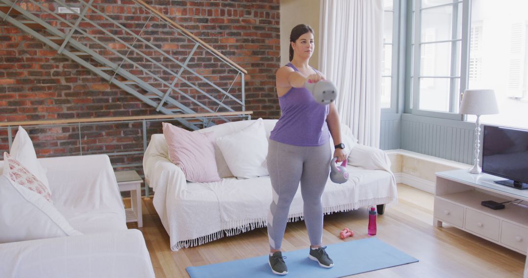 Woman Exercising with Dumbbells in Living Room for Home Workout - Free Images, Stock Photos and Pictures on Pikwizard.com