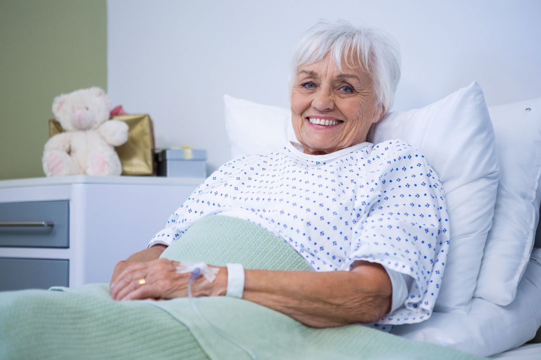 Portrait of smiling senior patient on bed - Free Images, Stock Photos and Pictures on Pikwizard.com