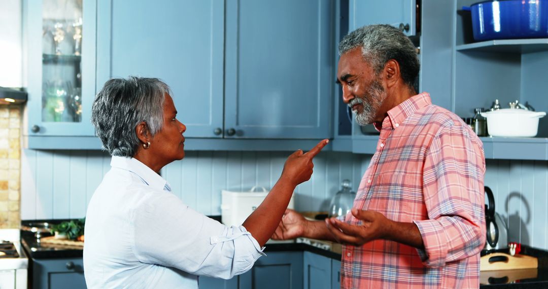 Mature Couple Having a Discussion in Kitchen - Free Images, Stock Photos and Pictures on Pikwizard.com