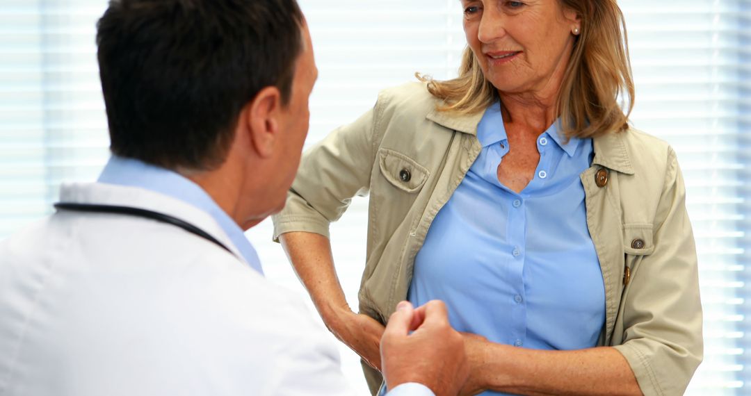 Doctor Checking Heartbeat of Middle-aged Woman During Examination - Free Images, Stock Photos and Pictures on Pikwizard.com