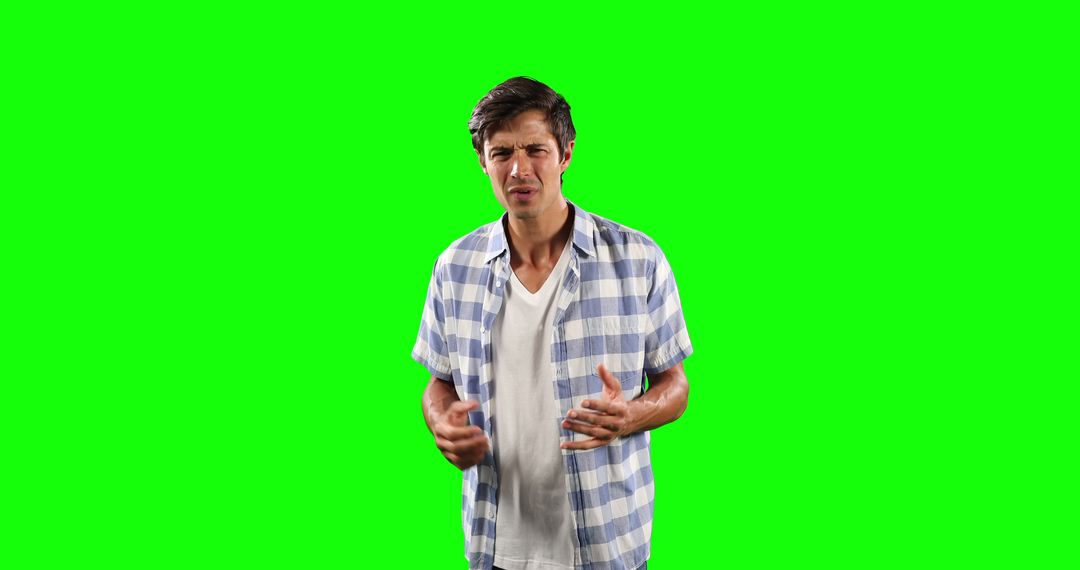 Disgusted Man Reacting in Checkered Shirt on Green Screen - Free Images, Stock Photos and Pictures on Pikwizard.com