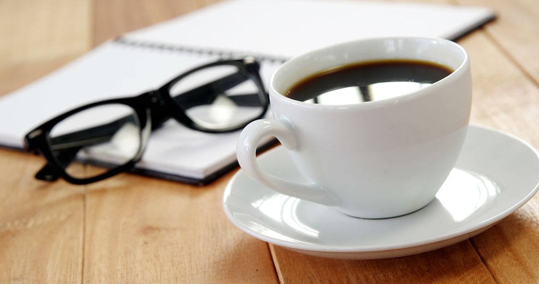 Coffee Cup, Notebook, and Glasses on Wooden Desk - Free Images, Stock Photos and Pictures on Pikwizard.com