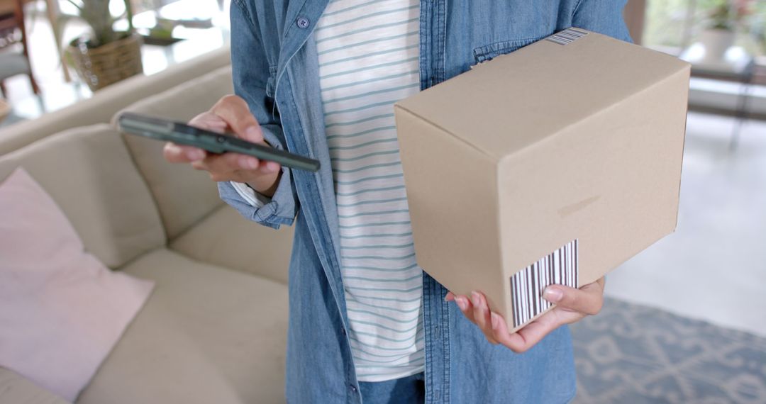 Woman using smartphone while receiving online delivery at home - Free Images, Stock Photos and Pictures on Pikwizard.com