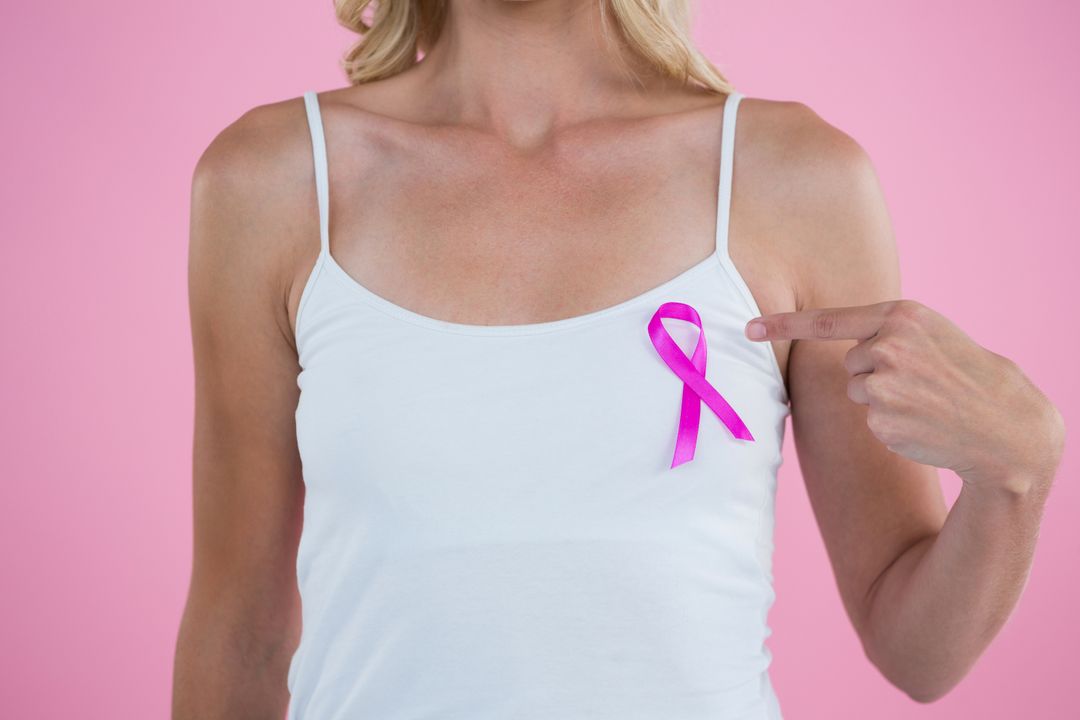 Mid section of woman pointing on Breast Cancer Awareness ribbon - Free Images, Stock Photos and Pictures on Pikwizard.com