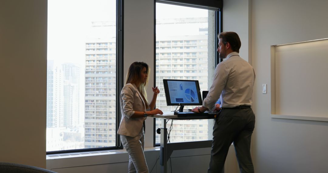 Business professionals discussing project with standing desk in modern office - Free Images, Stock Photos and Pictures on Pikwizard.com