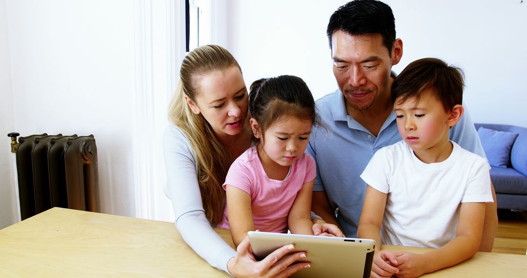 Diverse family using tablet together in living room - Free Images, Stock Photos and Pictures on Pikwizard.com