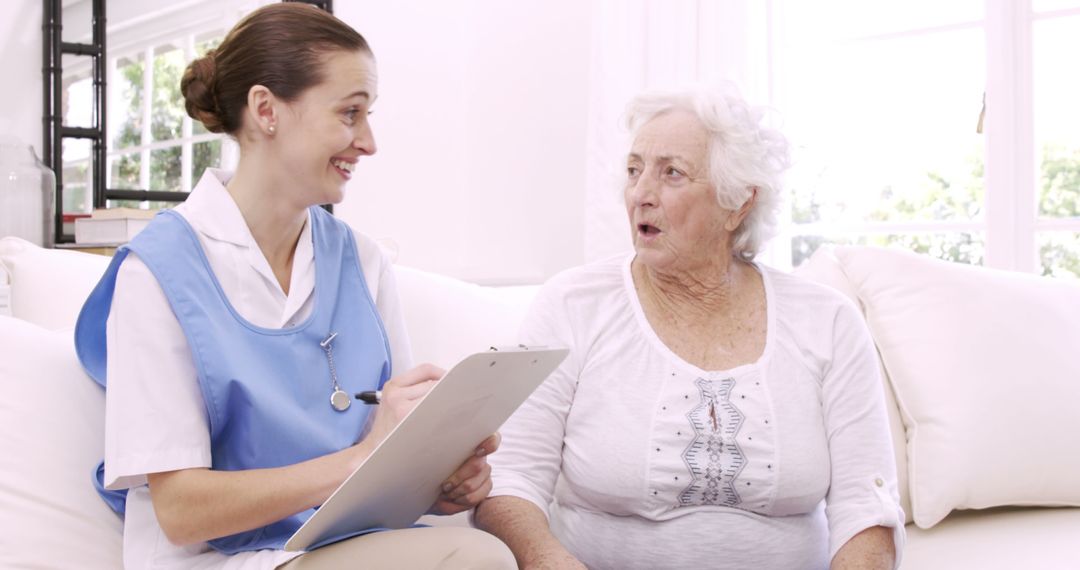 Healthcare Worker Talking to Senior Woman on Couch - Free Images, Stock Photos and Pictures on Pikwizard.com