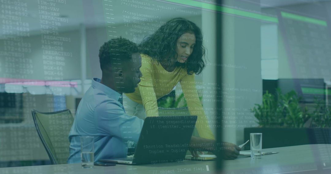 Software Developers Collaborating on Code in Modern Office Environment