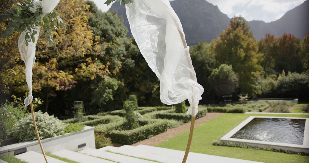 Garden with Flowing White Fabrics and Mountainous Background - Free Images, Stock Photos and Pictures on Pikwizard.com