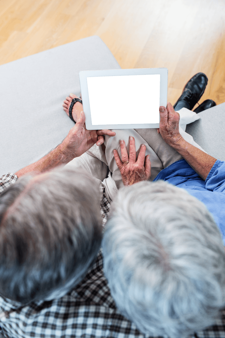 Transparent Overhead View of Senior Couple Using Tablet