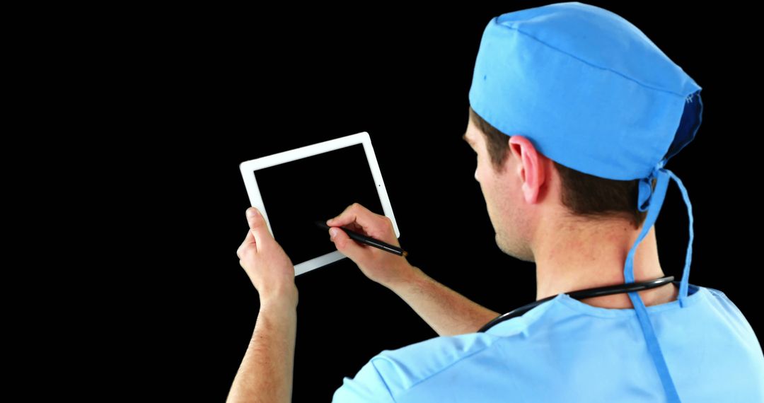 Male Doctor Using Tablet with Stylus on Black Background - Free Images, Stock Photos and Pictures on Pikwizard.com