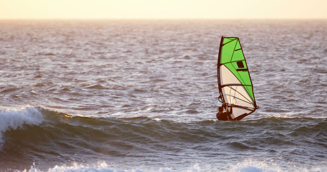 Windsurfer Catching Waves at Sunset on the Ocean - Free Images, Stock Photos and Pictures on Pikwizard.com