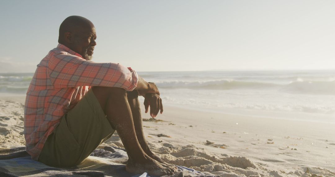 Contemplative Man Relaxing on Beach during Sunset - Free Images, Stock Photos and Pictures on Pikwizard.com