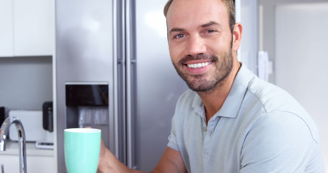 Smiling Man Holding Coffee Cup in Modern Kitchen - Free Images, Stock Photos and Pictures on Pikwizard.com