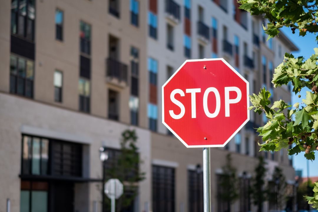 Stop Sign in Front of Urban Apartment Complex