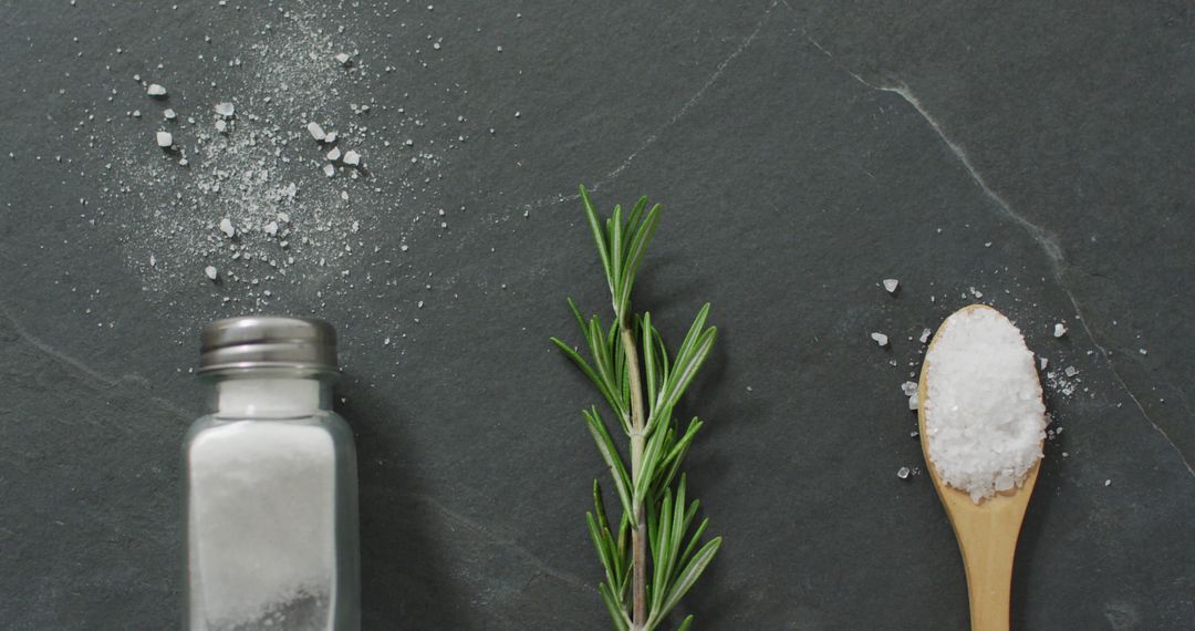 Rosemary and Salt Arrangement on Stone Background