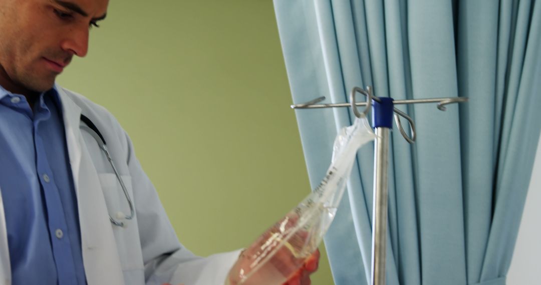 Professional Doctor Examining IV Fluid Bag in Hospital Room - Free Images, Stock Photos and Pictures on Pikwizard.com