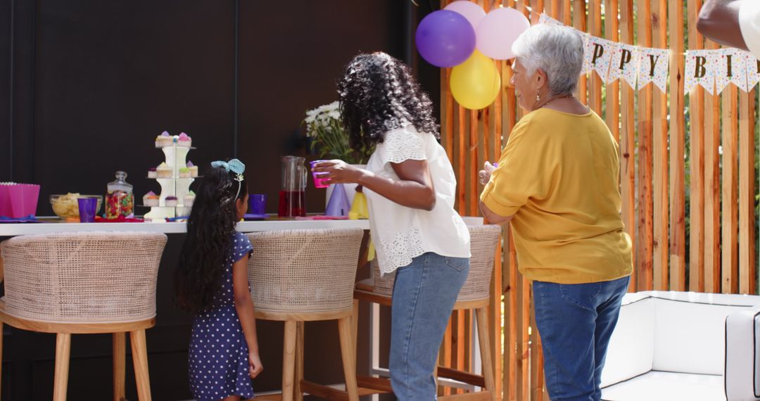 Three Generations Preparing Party Table at Home Celebration