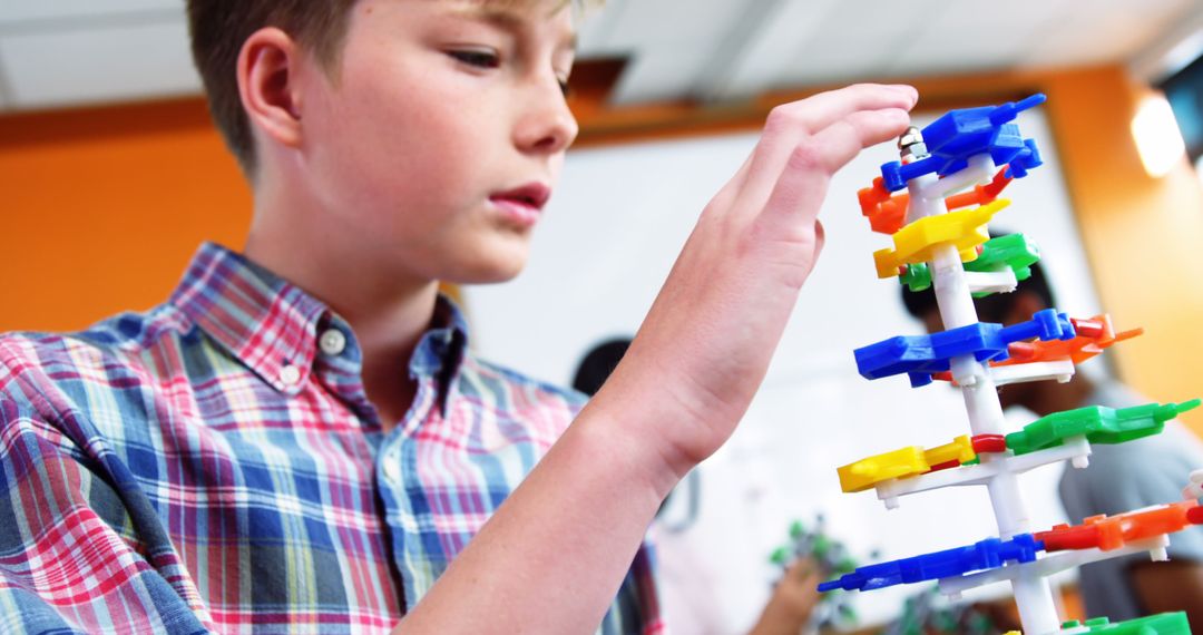 Young Boy Building Colorful DNA Model in Classroom - Free Images, Stock Photos and Pictures on Pikwizard.com