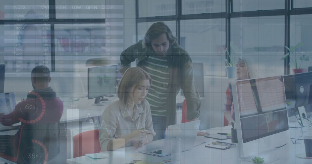 Diverse Team Analyzing Financial Data on Computers in Modern Office