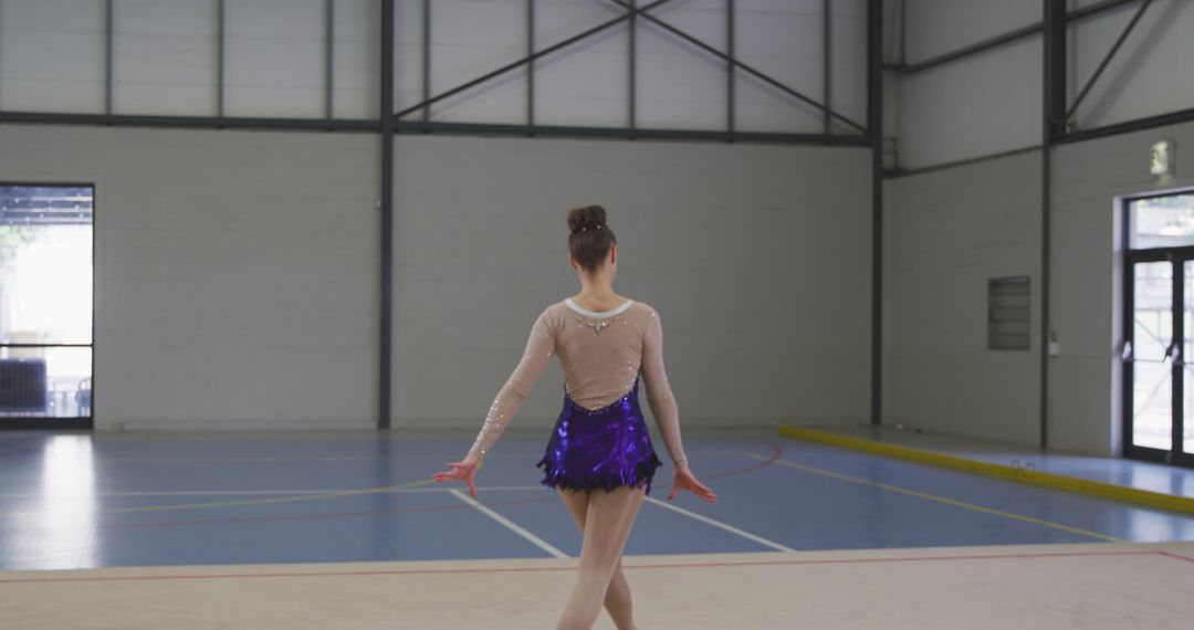 Young Gymnast Performing Rhythmic Routine in Sports Hall - Free Images, Stock Photos and Pictures on Pikwizard.com